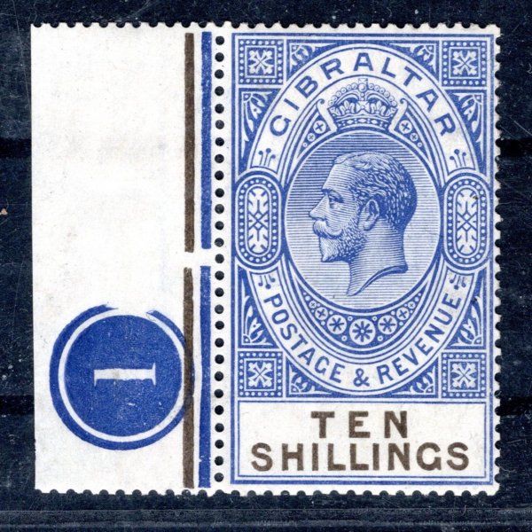 Gibraltar - SG. 106, (Mi. 90), Jiří V, 1925, 10 Sh modrá/černá s okrajem a deskovou značkou, nálepka na okraji mimo známku, dekorativní kus